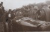 Fotografía del príncipe de Asturias ante el automóvil del carrerista Lee Guinnes, participante en el II Gran Premio de San Sebastián y en el que murió el mecánico Barret