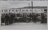 Fotografía del piloto Tazio Nuvolari conversando junto a su automóvil Maserati